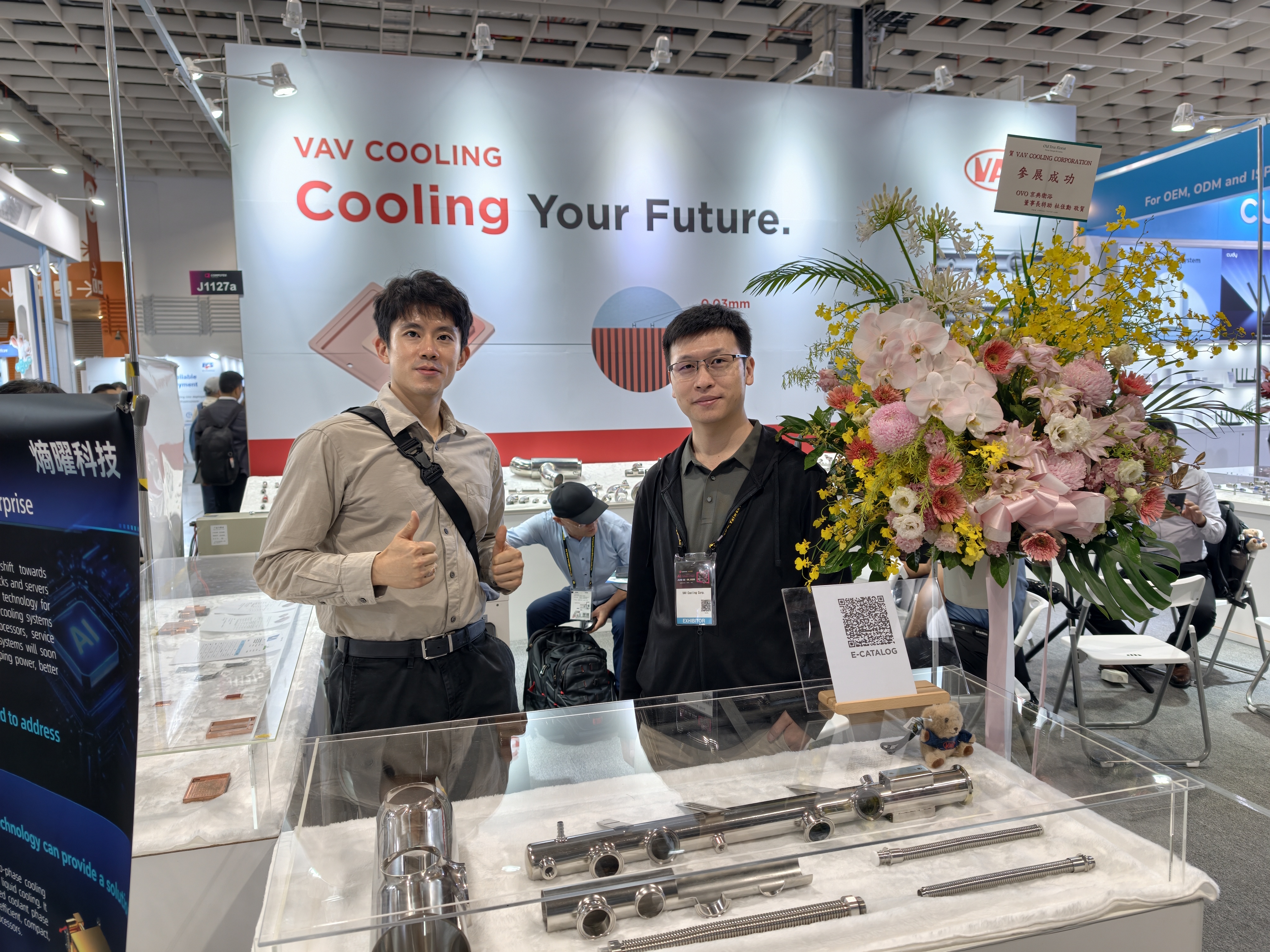 Bert with a VAV Cooling R&D engineer at Computex, standing in front of stainless cooling components and manifolds.