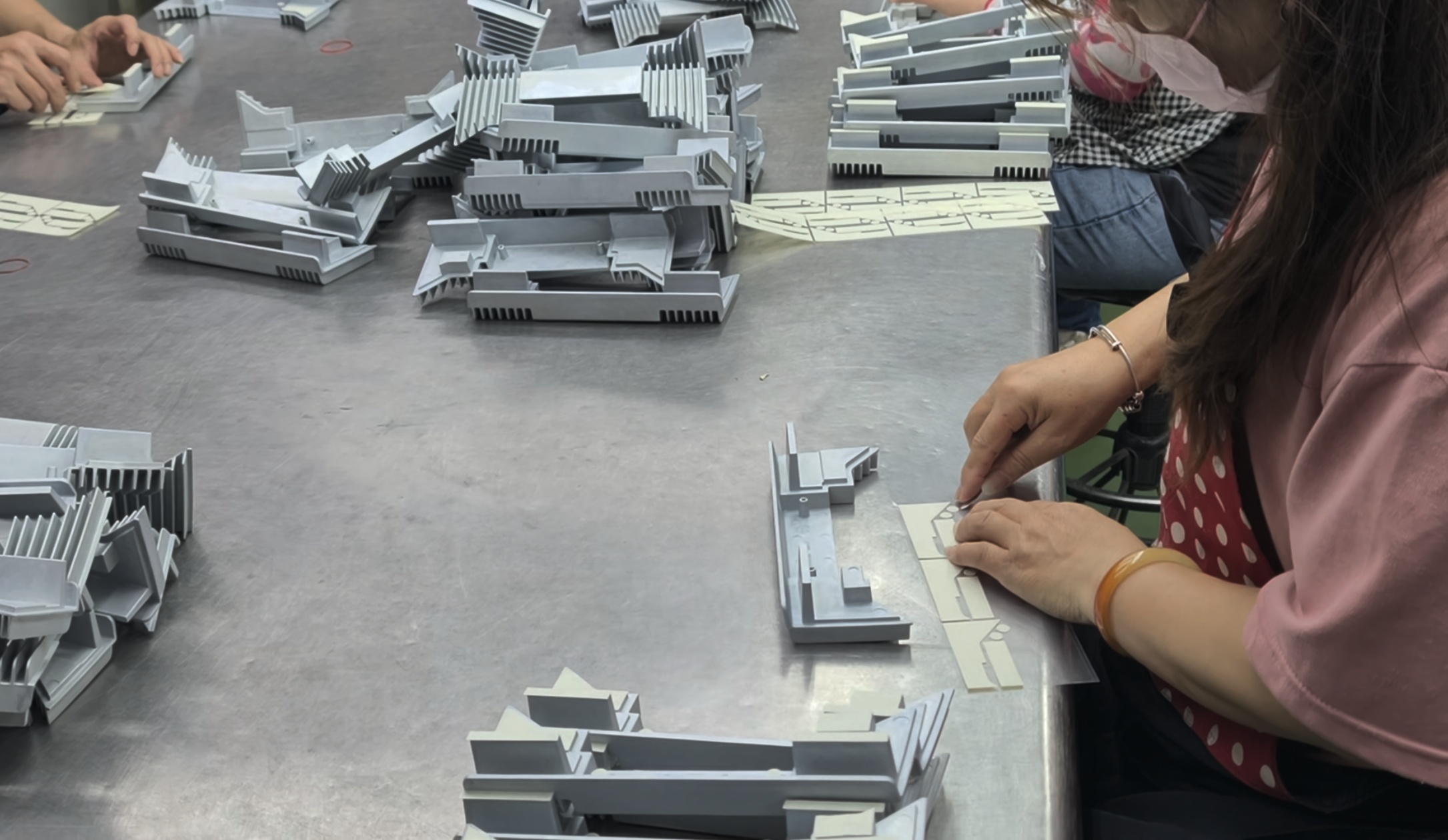 Masking applied to parts before coating in a Taiwan paintshop.