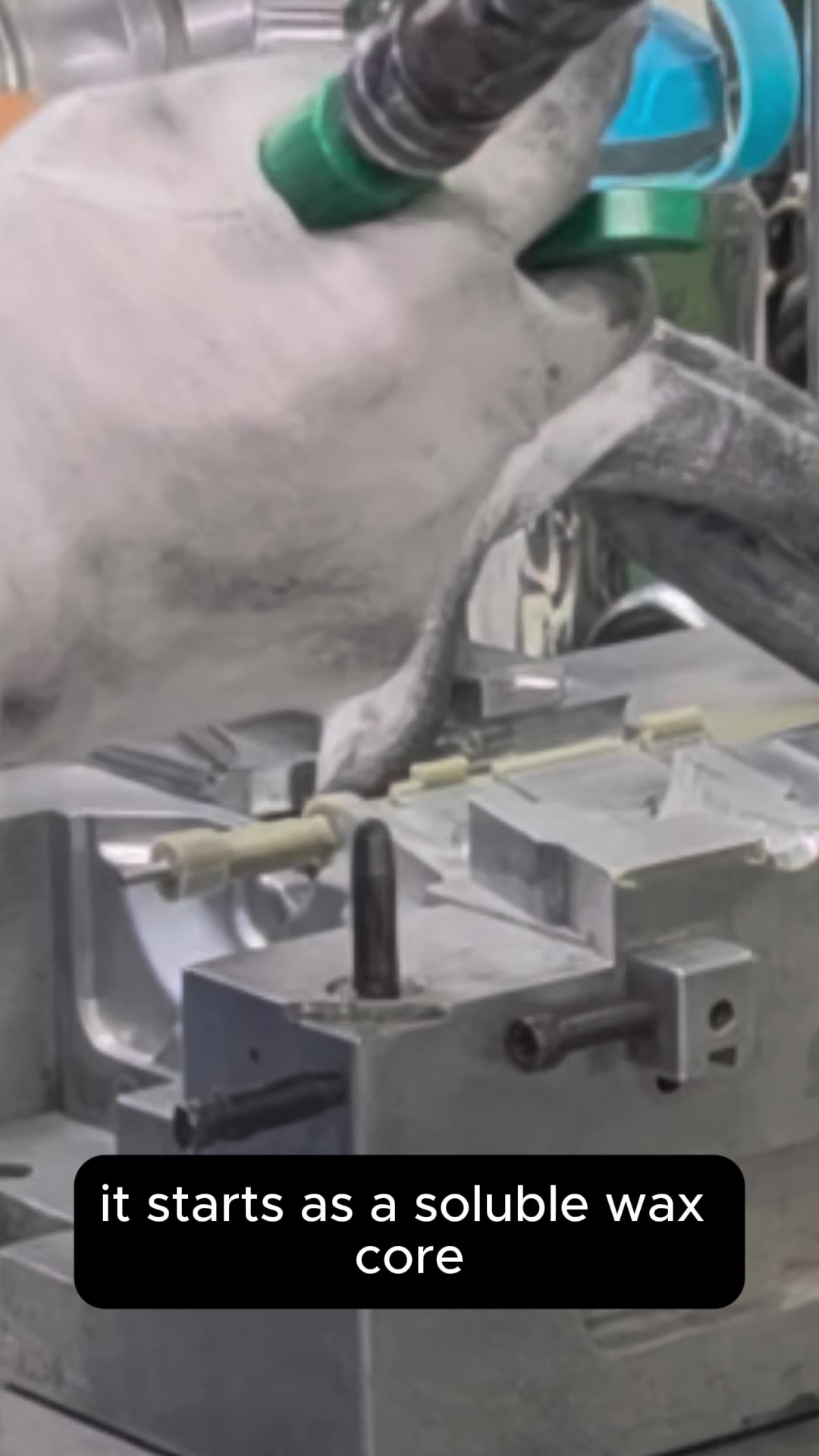 A gloved hand working with a wax core inside an investment casting mold in Taiwan.